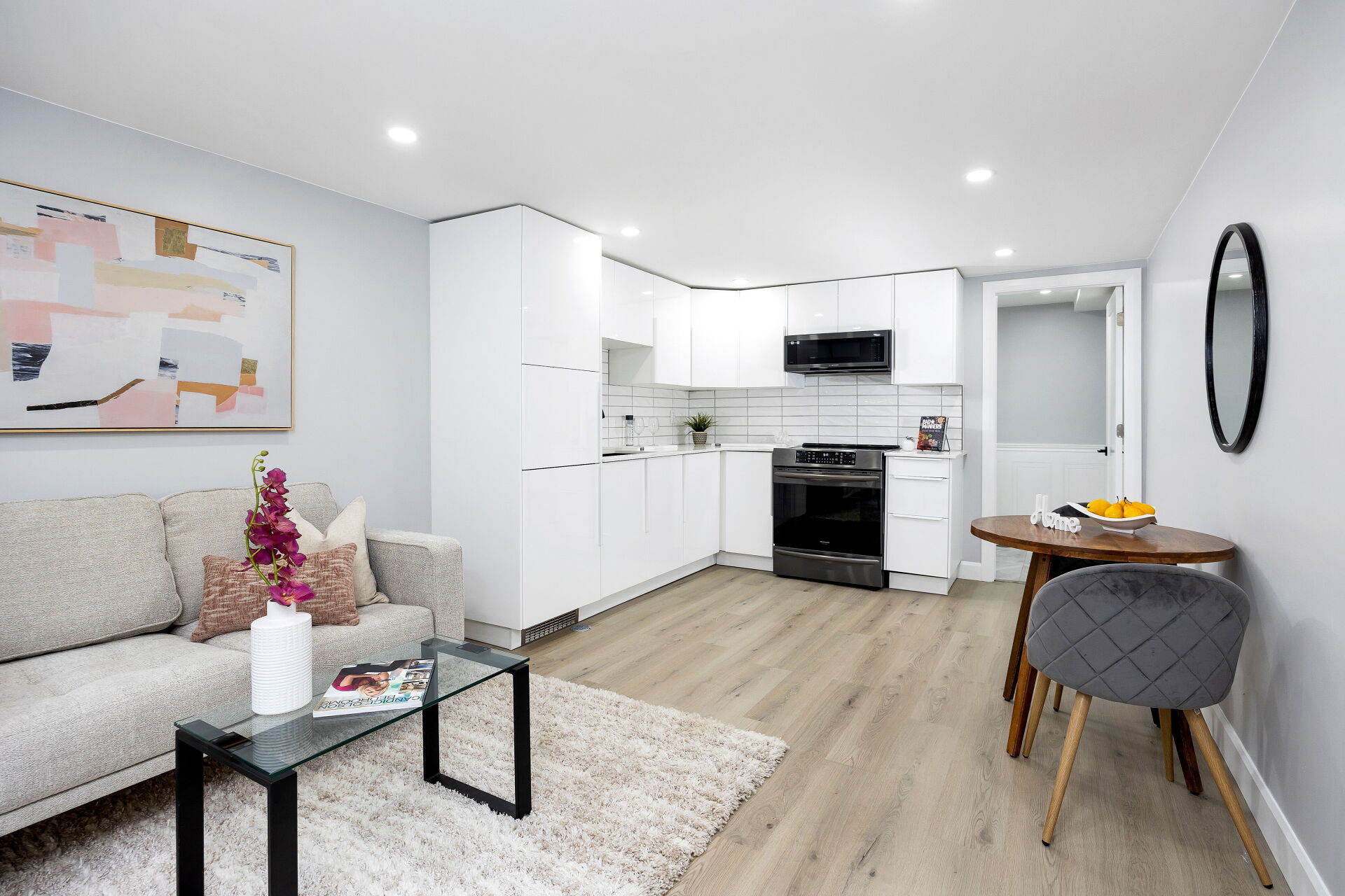 Living, kitchen and dining areas in one open-concept lower-level space.