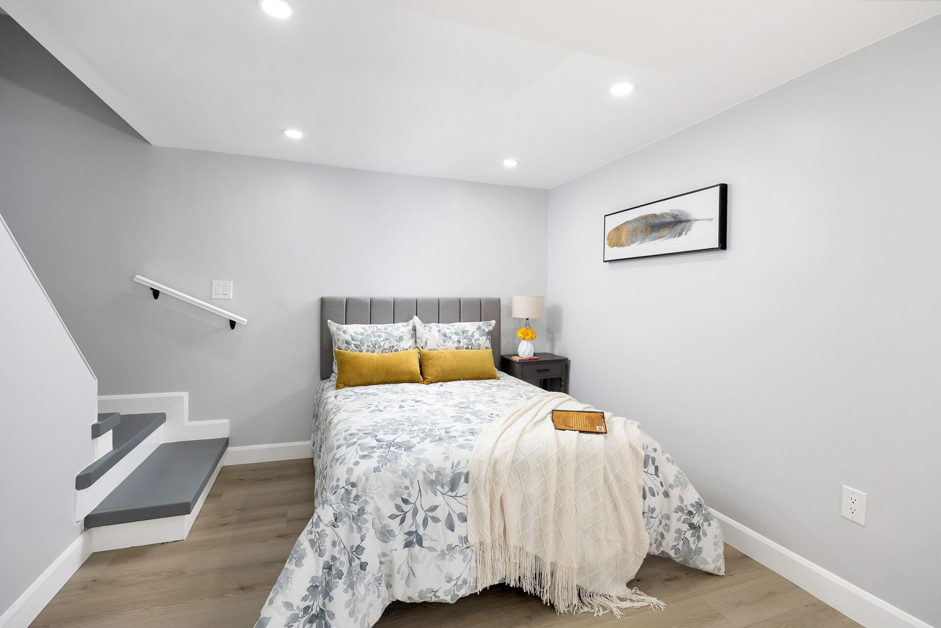 Staged sleeping area beside a short staircase.